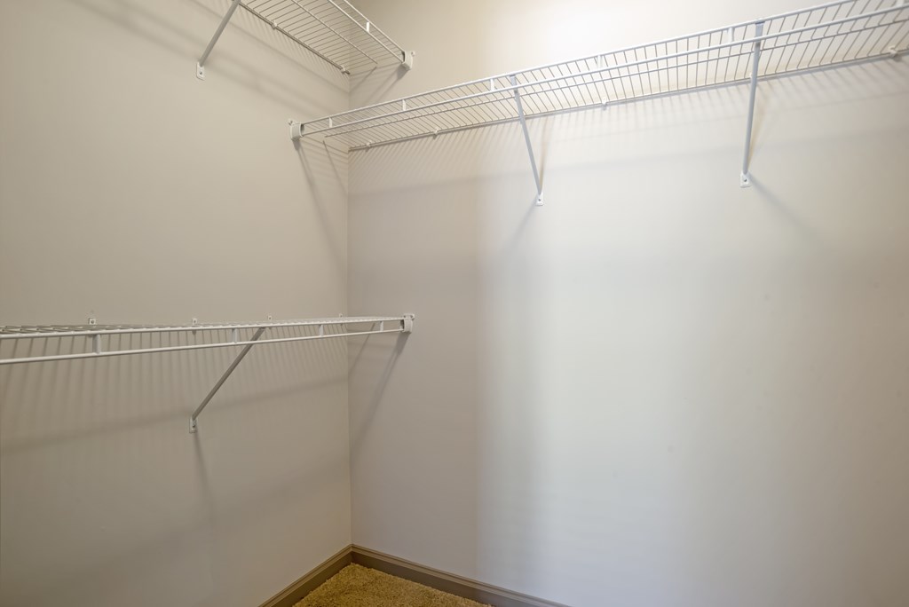 Empty white shelves in a room.